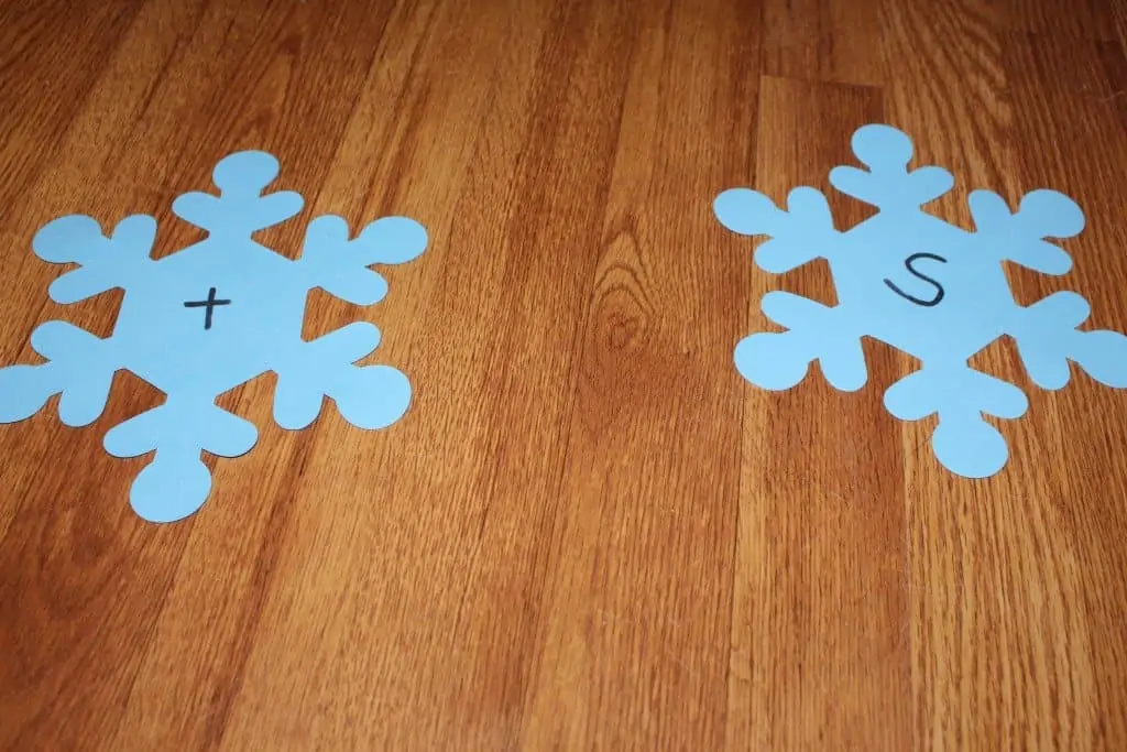 foam snowflakes with the letter "t" and "s" written on them in black marker