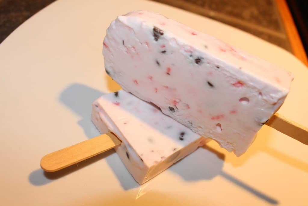 a stack of 2 completed peppermint bark popsicles