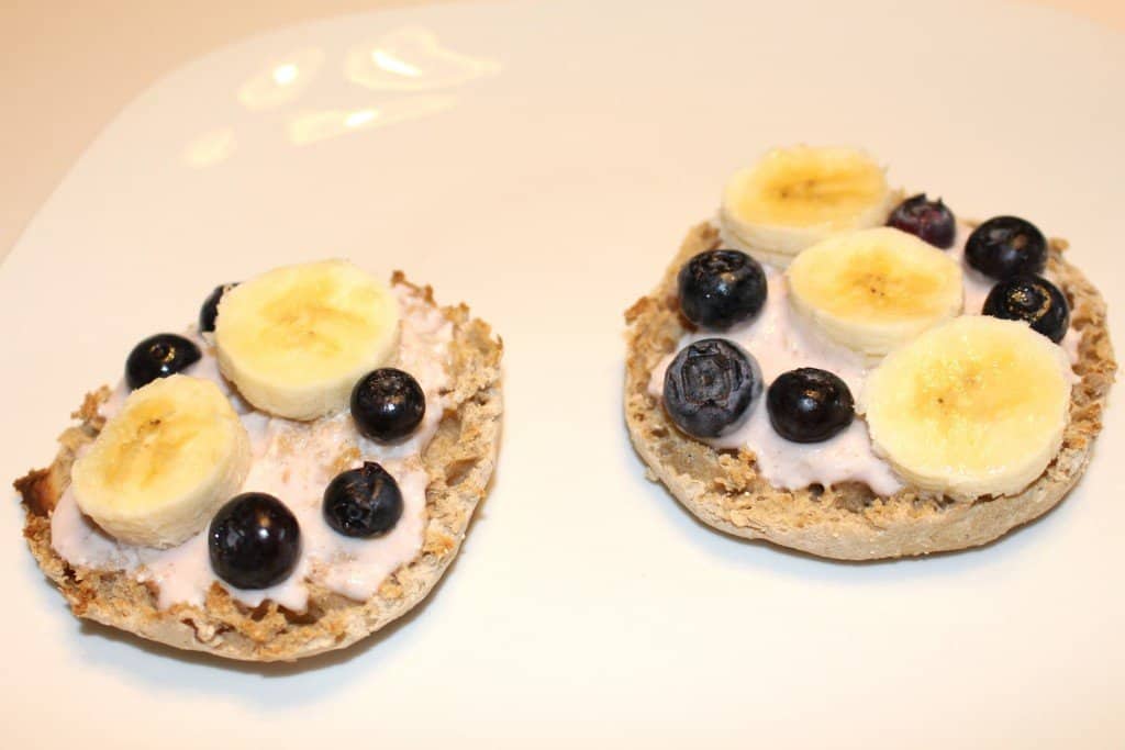 english muffin breakfast pizza topped with yogurt and fruit