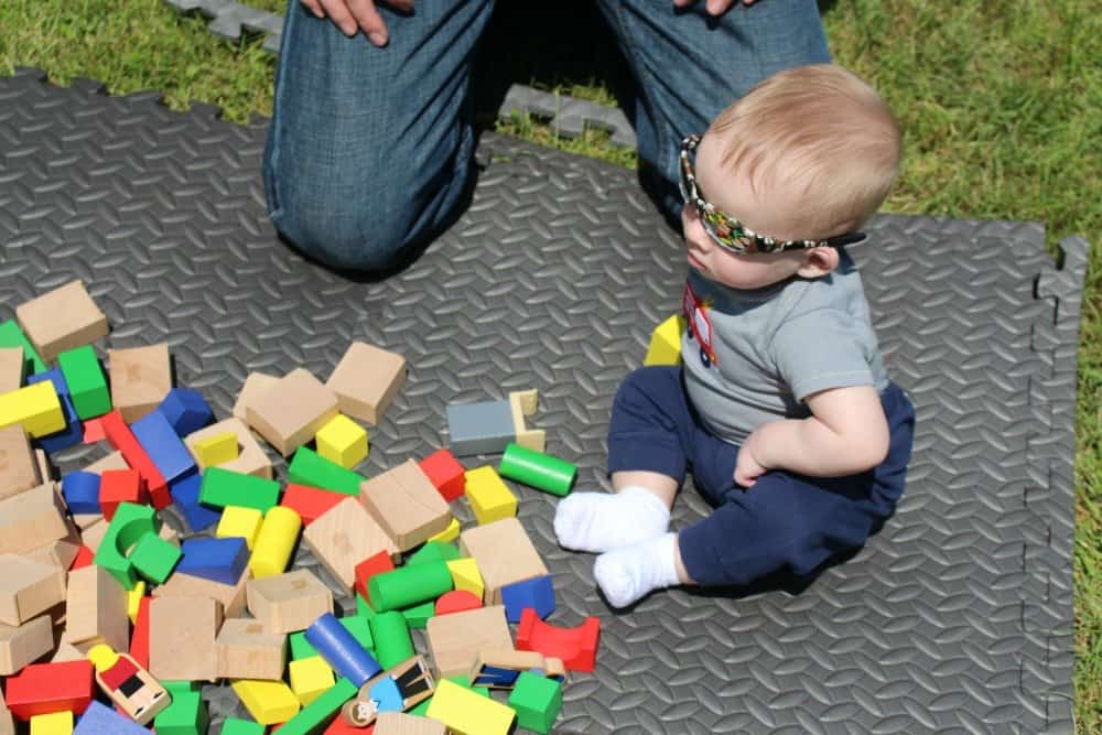 small child playing with building blocks