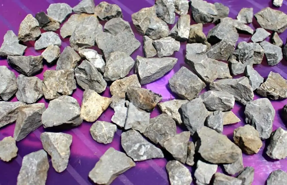 gray rocks laying on a purple art tray