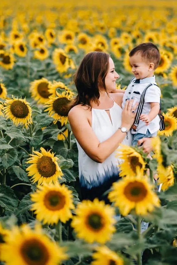 Happy mother and son enjoying a sunflower field together, representing sunflower fields in tri-cities tn.