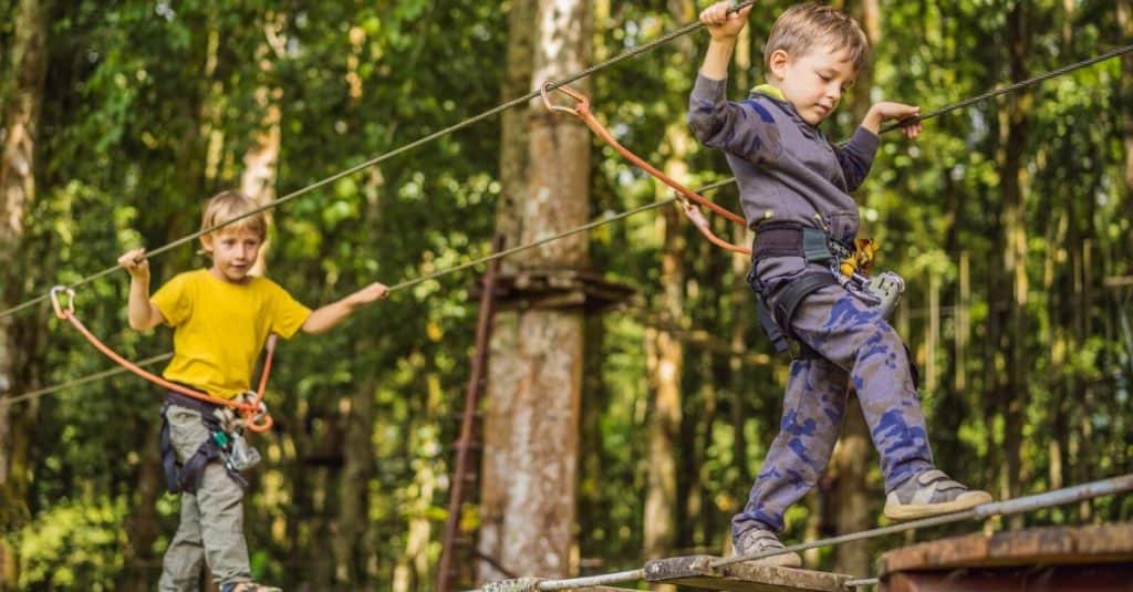 Things to Do Outside in the Smoky Mountains: two young kids completing a ropes course