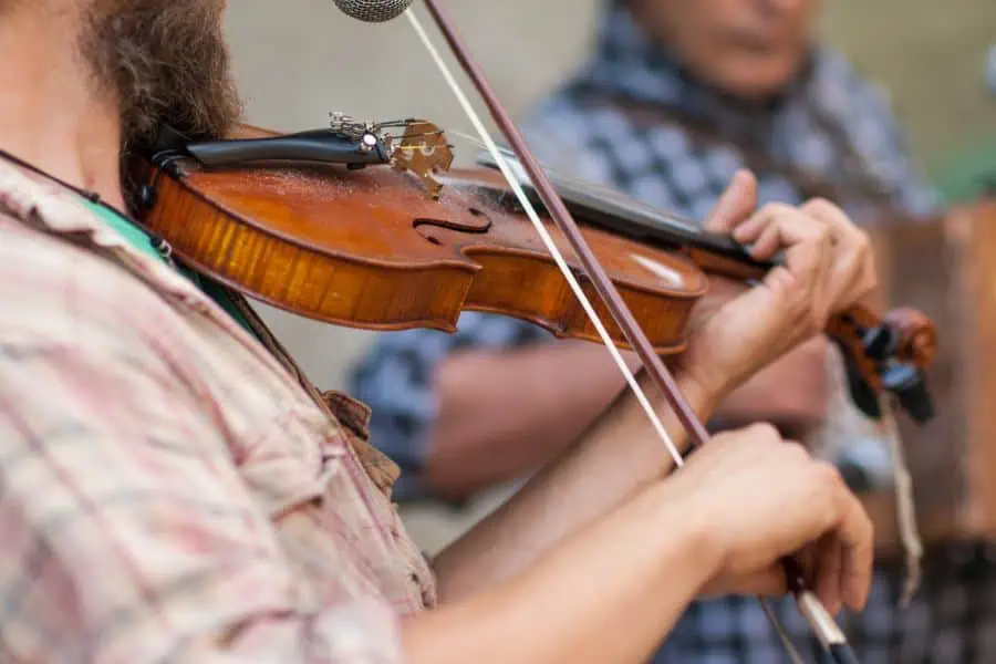 Man playing fiddle in a band representing free concerts near Knoxville TN