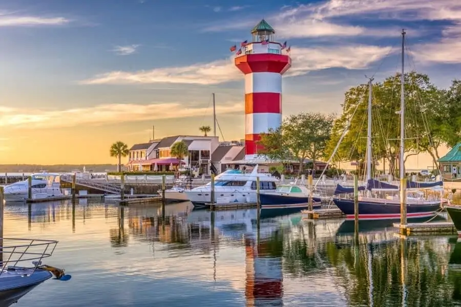 Beaches Near Knoxville: Hilton Head Island, SC red and white lighthouse behind sailboats in marina