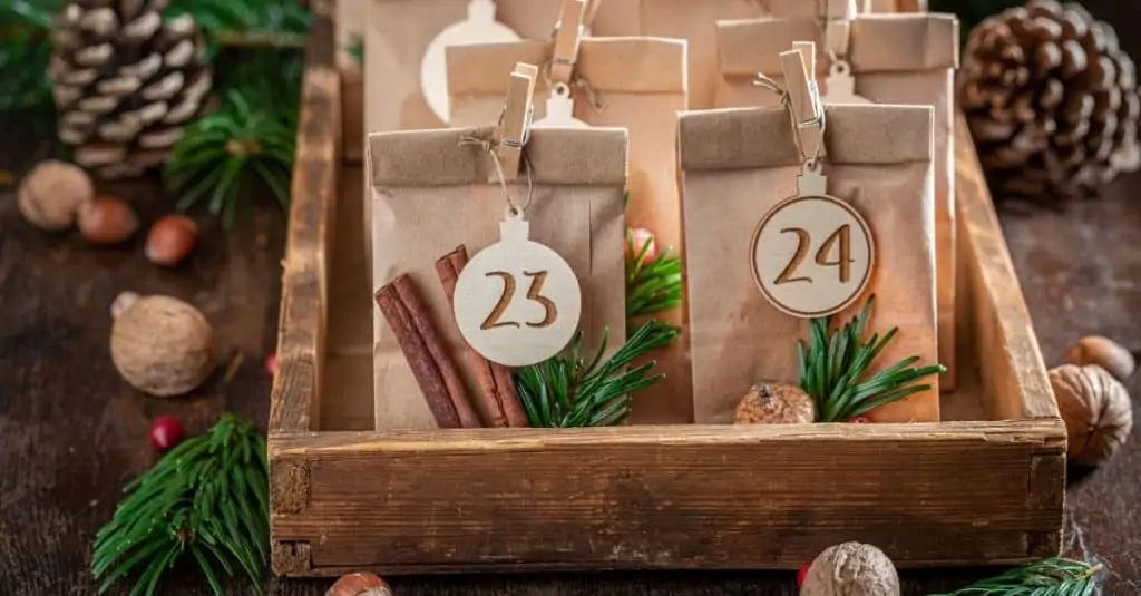 paper bag advent calendar in rustic box with pine branches, representing Knoxville TN Christmas Craft Fairs