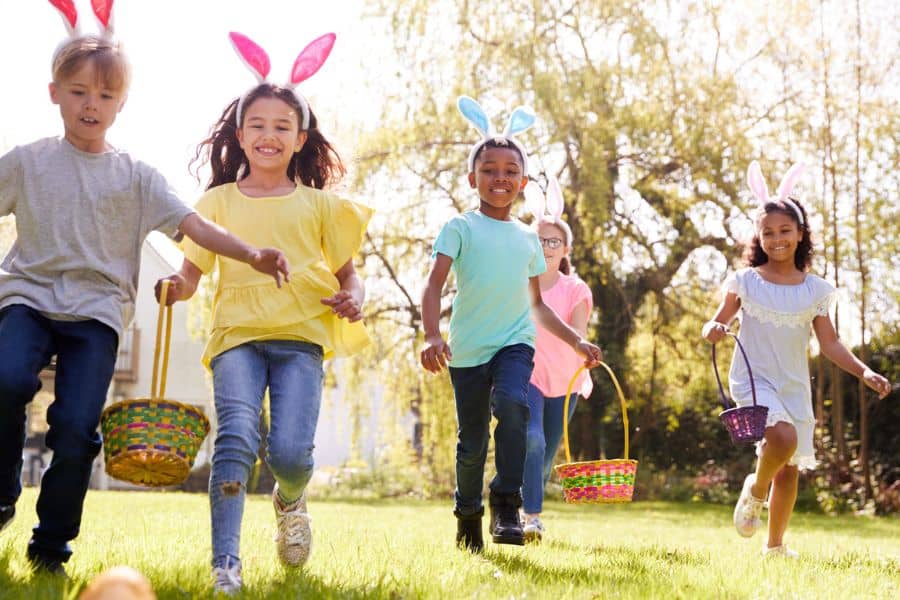 Kids running with Easter baskets in a field representing Easter events near Knoxville TN