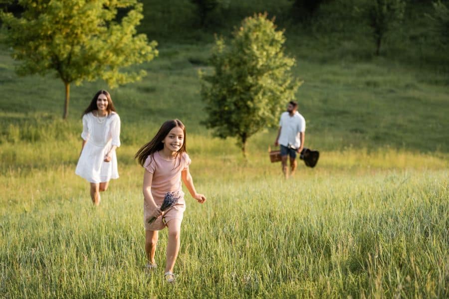 family walking through a sunny field representing things to do in Chattanooga in June
